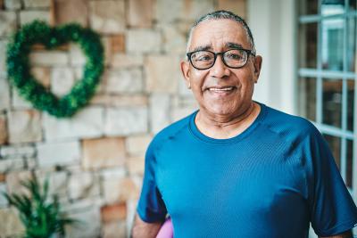 Smiling senior man outside his home